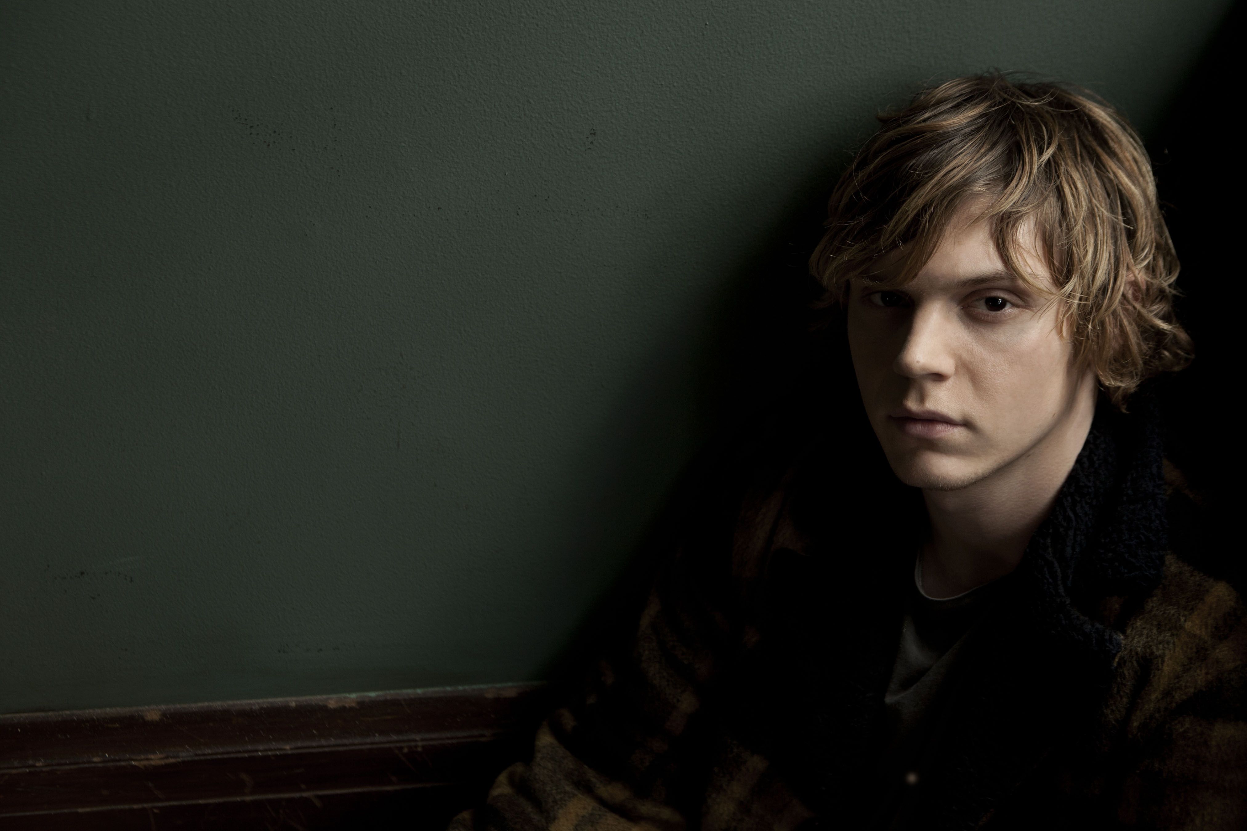 A young man sitting on the floor - Evan Peters