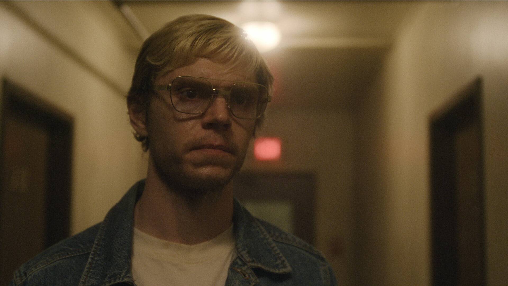 A man in glasses standing alone - Evan Peters