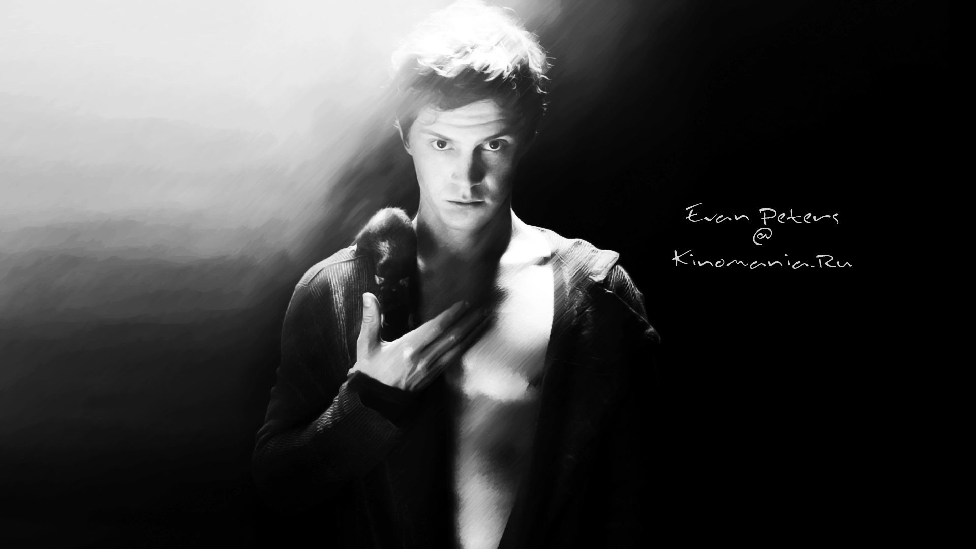 A man holding an object in his hand - Evan Peters