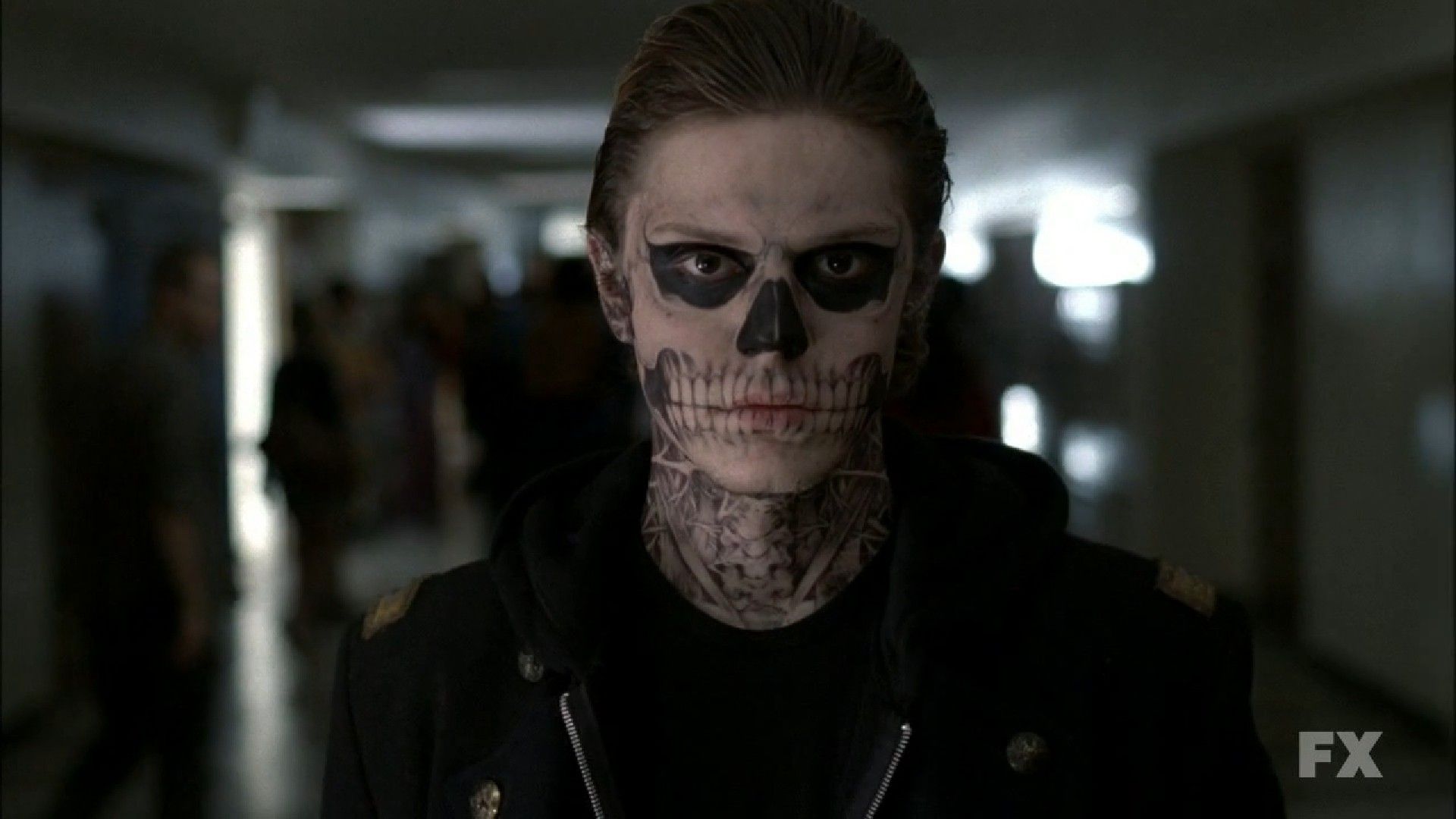 A man with black hair and white face paint - Evan Peters, horror