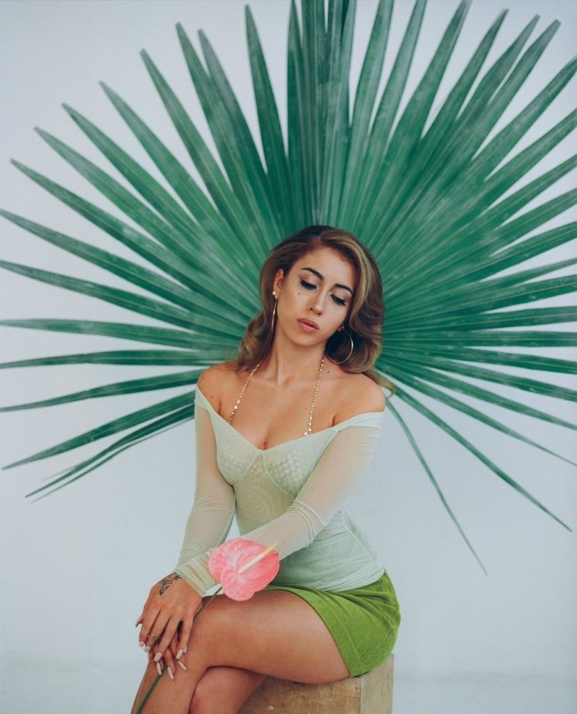 A woman sitting on top of something - Kali Uchis