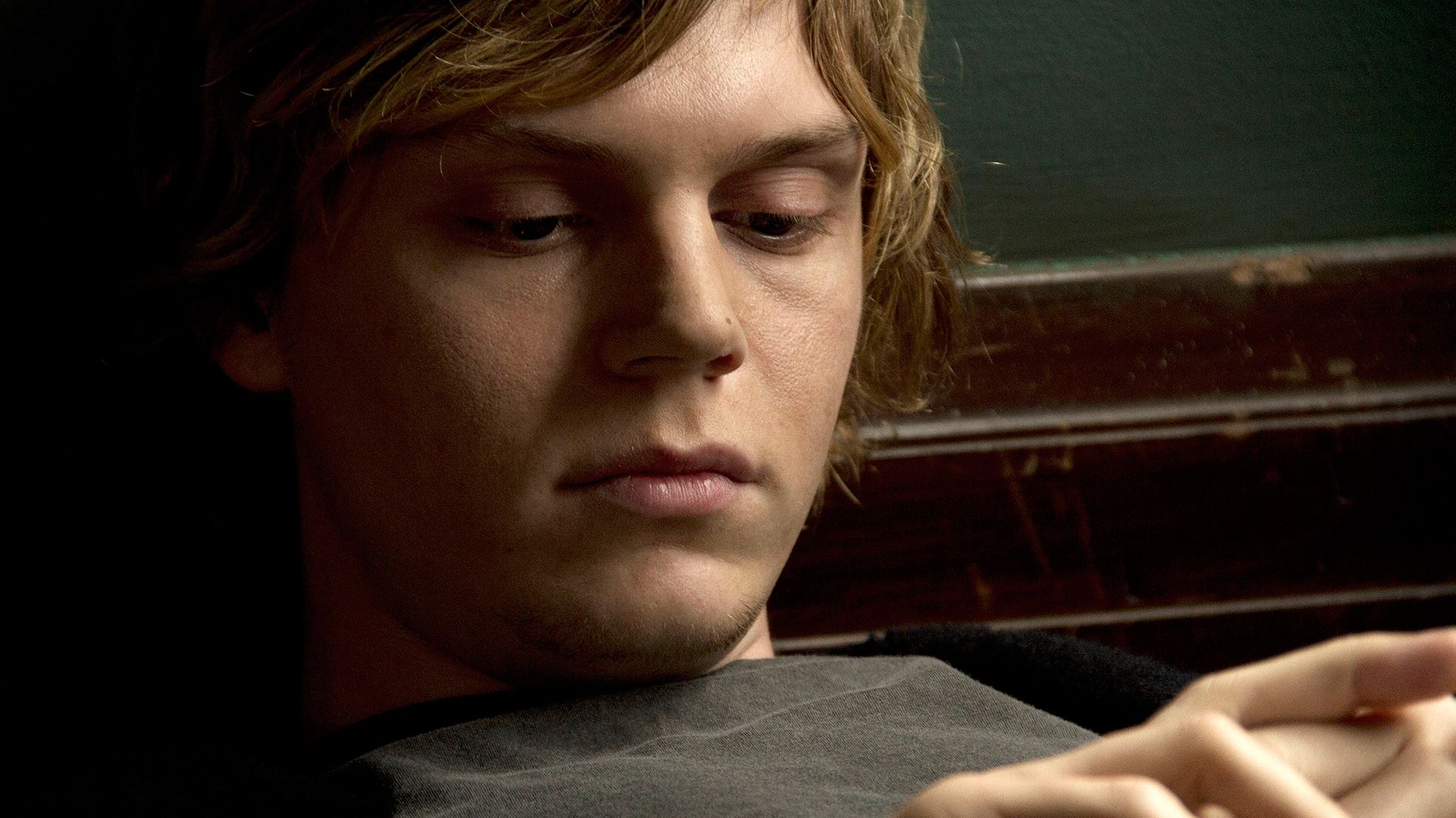 Tate from American Horror Story: Asylum sitting on a bench - Evan Peters