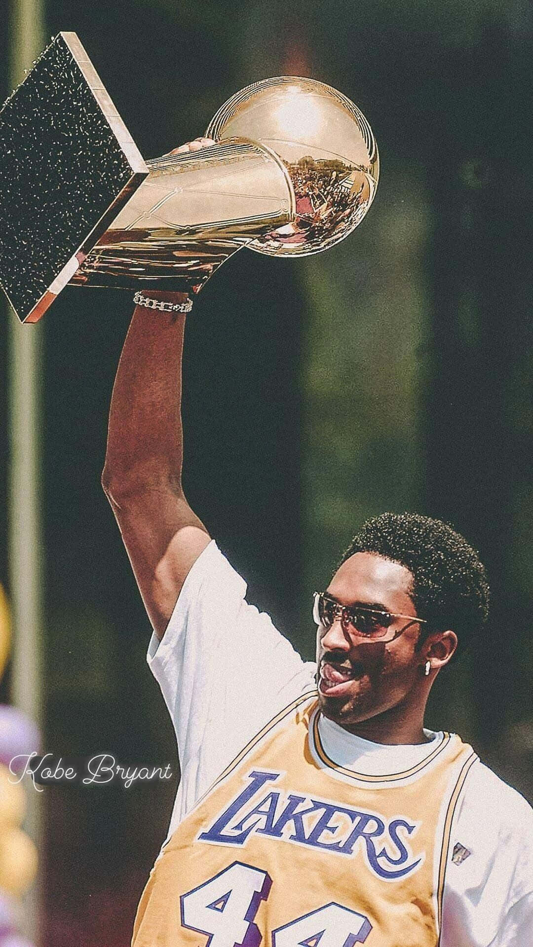 Kobe Bryant holding up the NBA championship trophy - NBA, Kobe Bryant