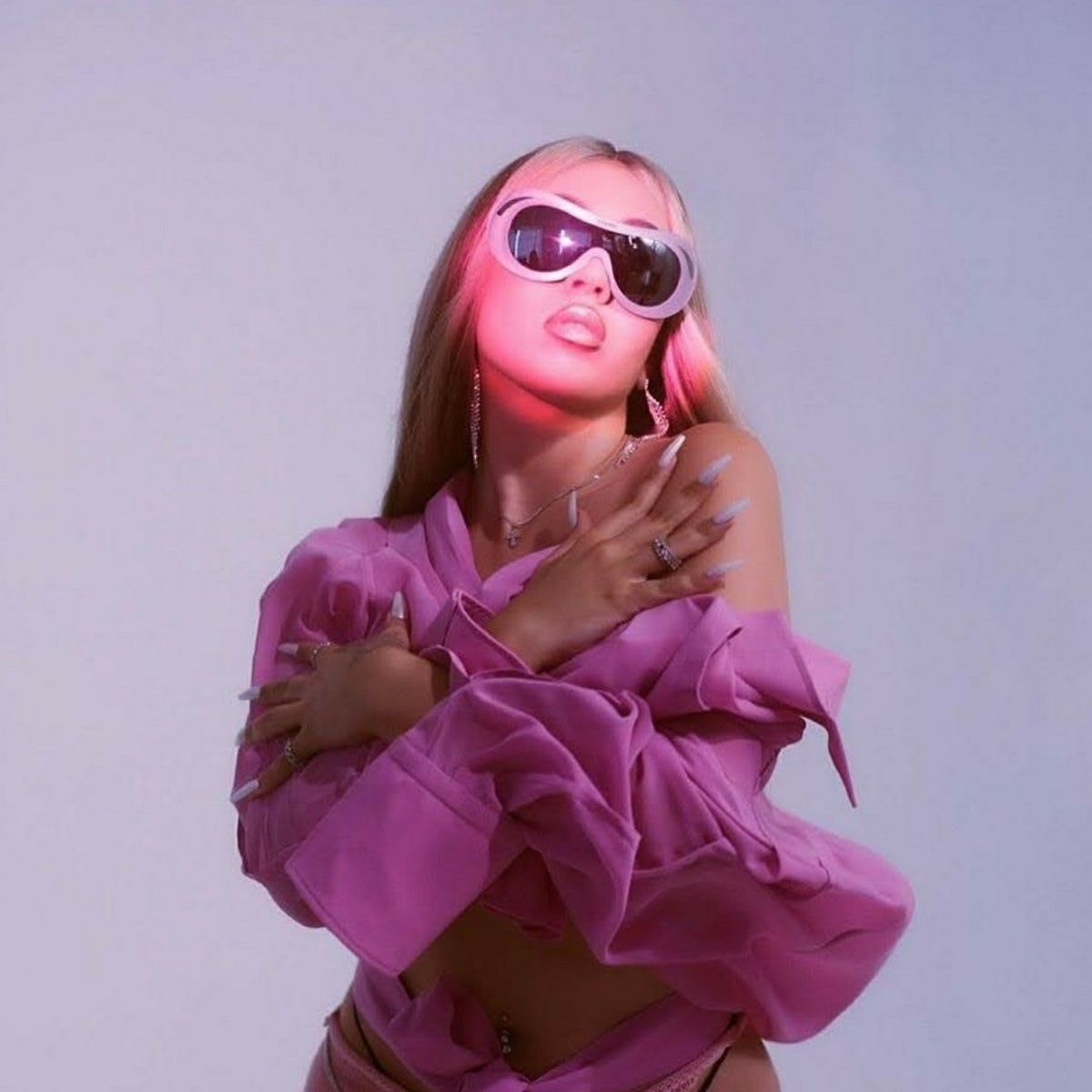 A woman with pink hair and sunglasses - Kali Uchis