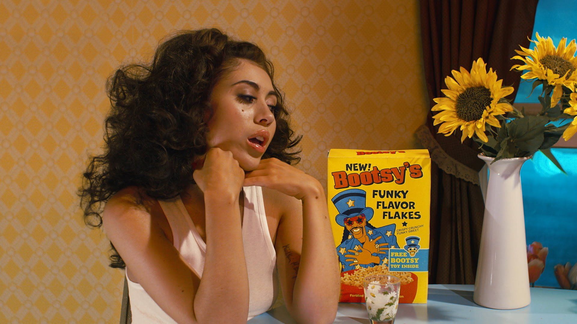 A woman sitting at the table with cereal - Kali Uchis