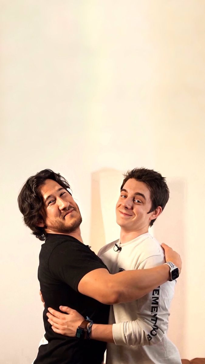 Two guys smiling and hugging each other - Markiplier