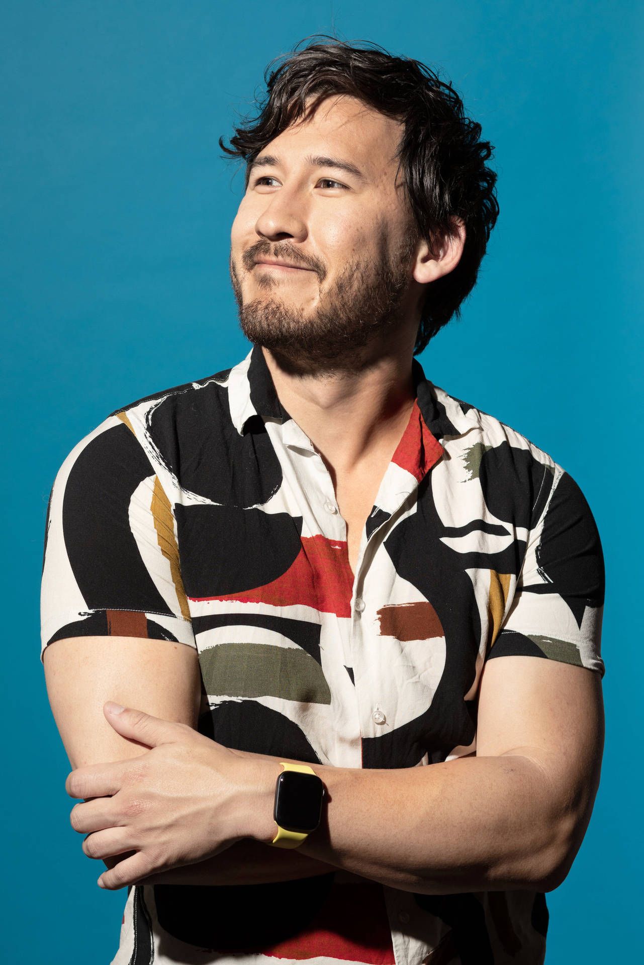 Portrait of man with arms crossed wearing a colorful shirt - Markiplier