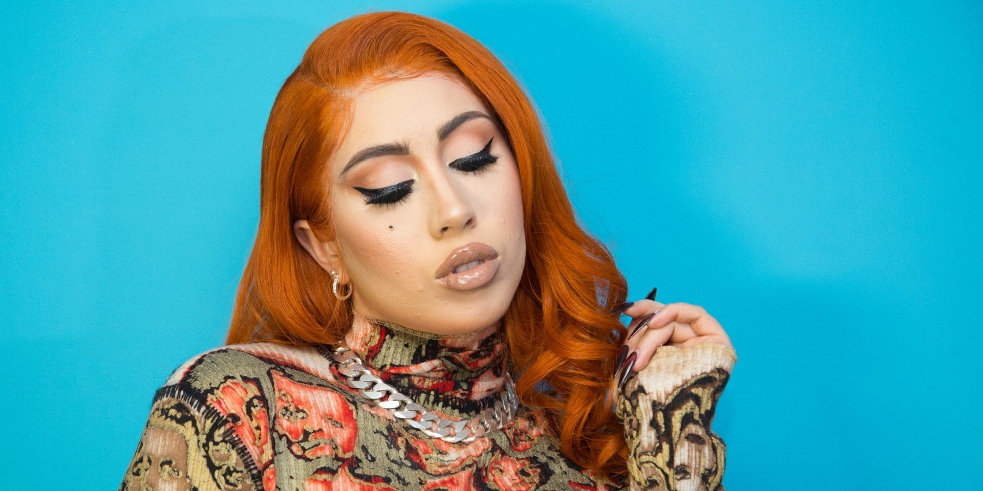 A woman with red hair and makeup - Kali Uchis