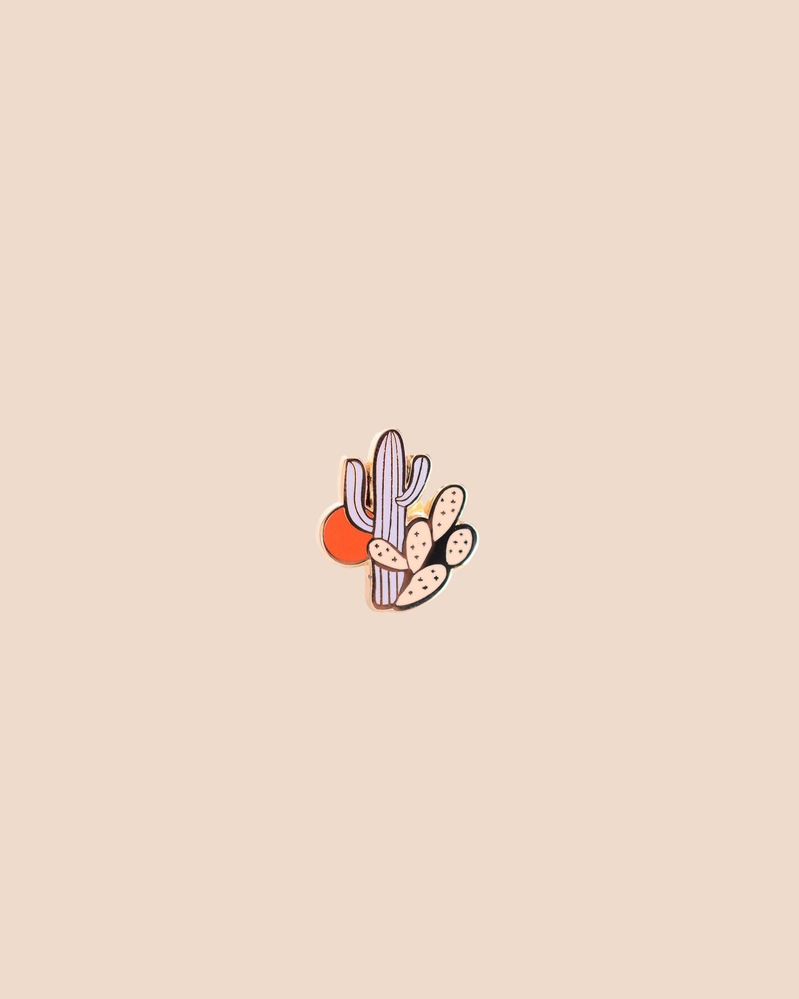 A cute cactus enamel pin with a sun in the background - Salmon