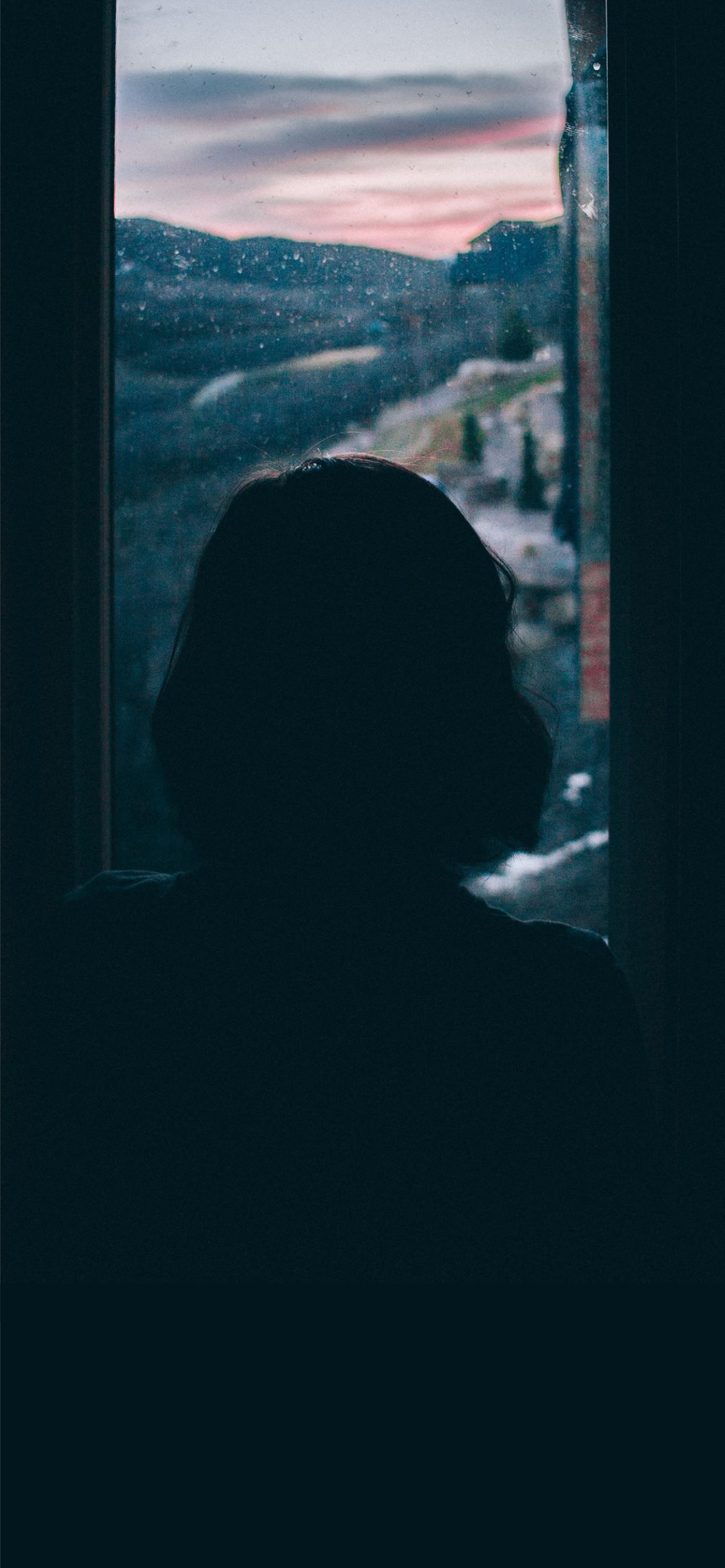 A woman's silhouette is seen in front of a window - Sad, depressing, sad quotes, depression