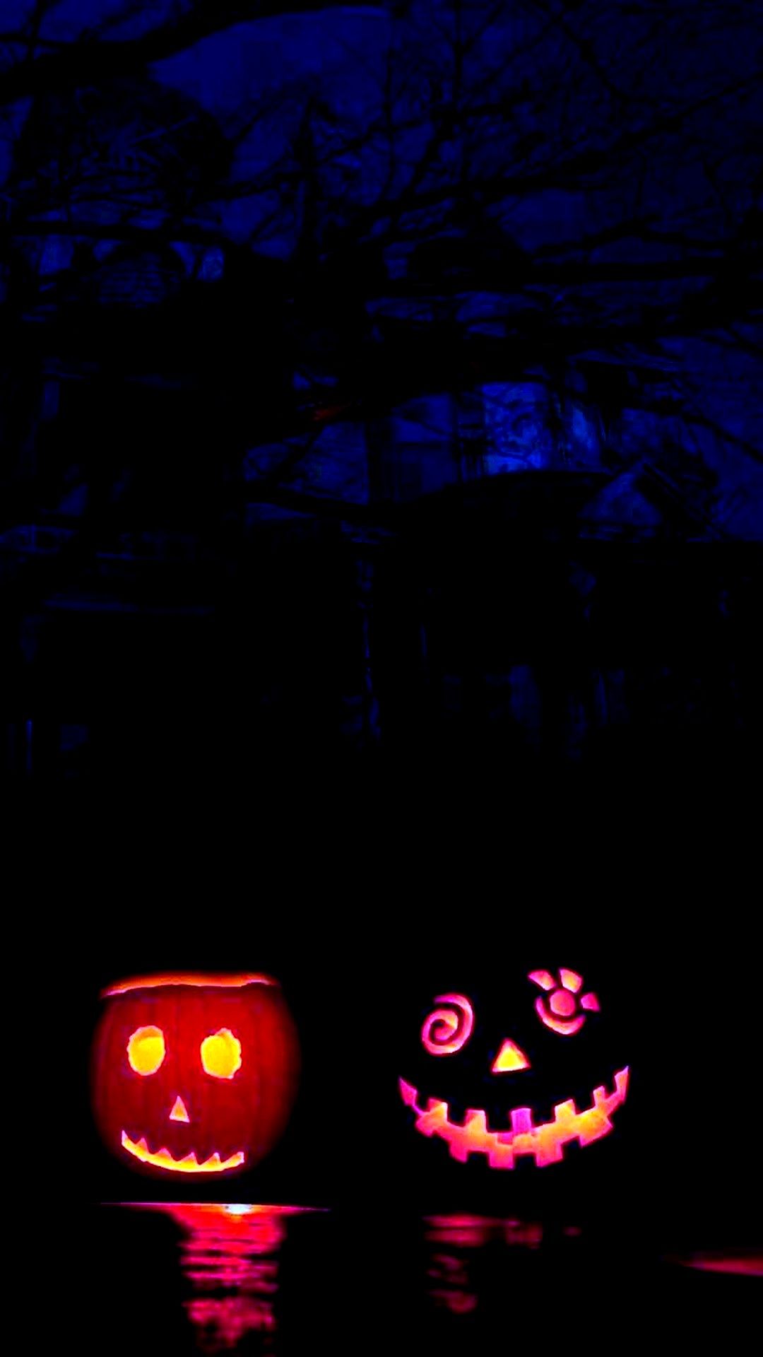 Two pumpkins sitting on a dark street - Cute Halloween