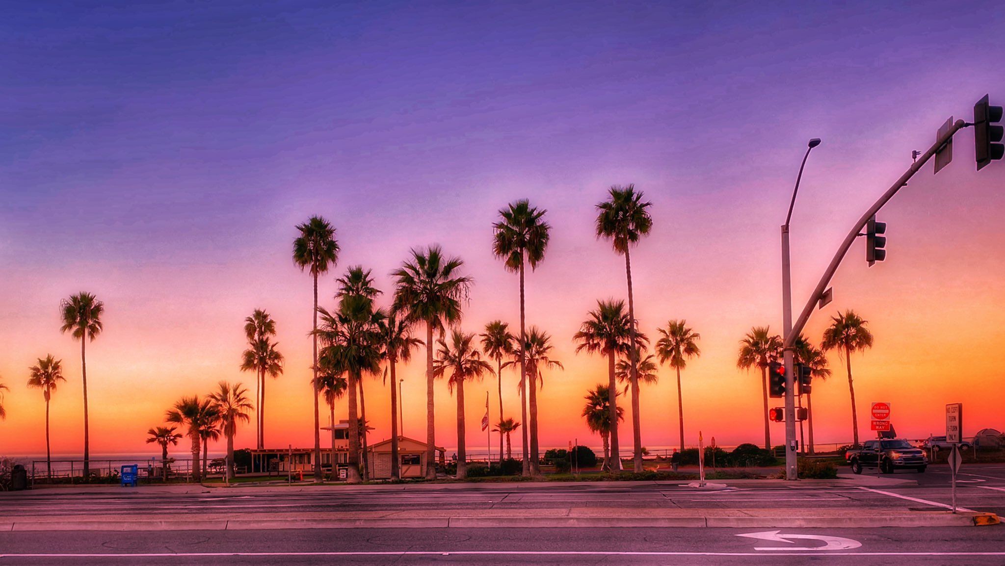 A street with palm trees and an intersection - California