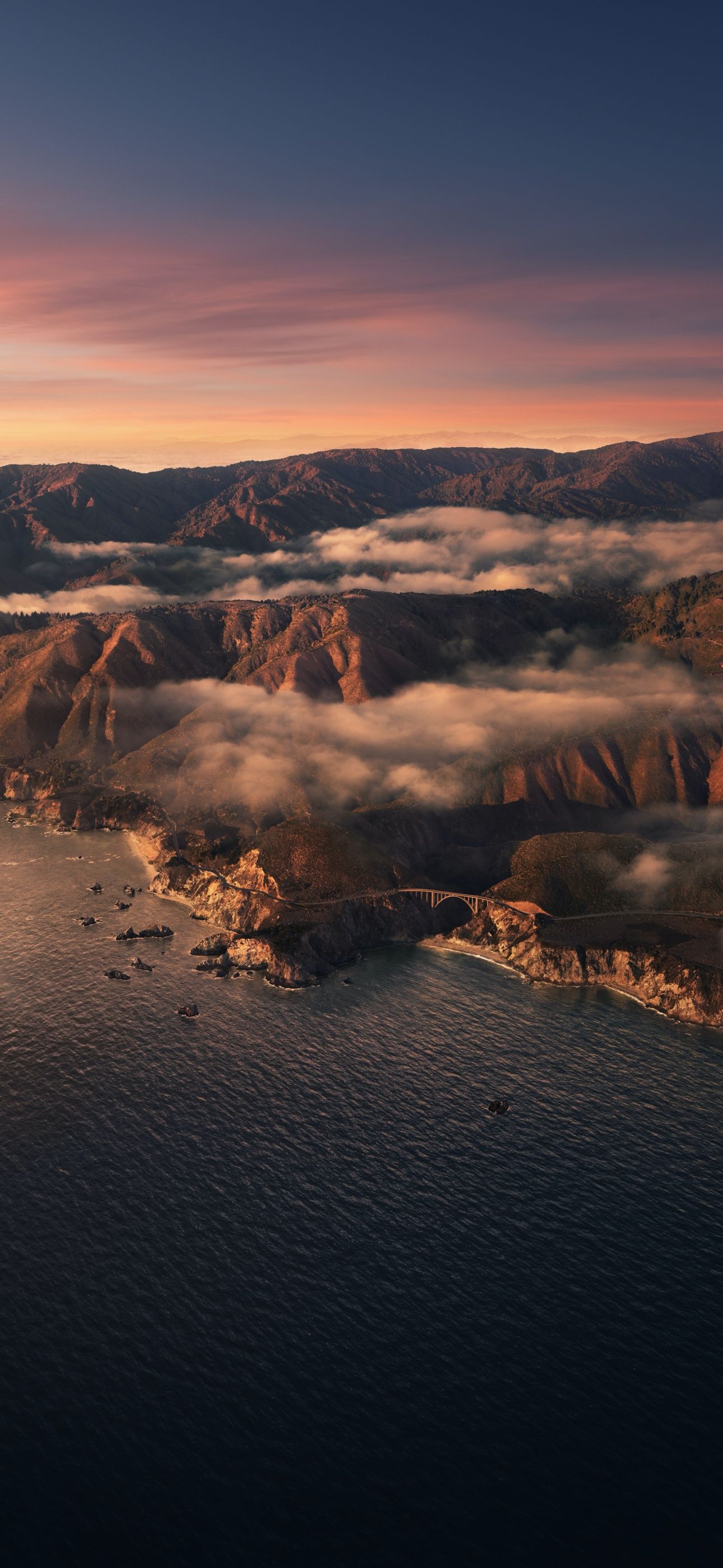 Aerial view of a coastal town surrounded by mountains - California, sunrise