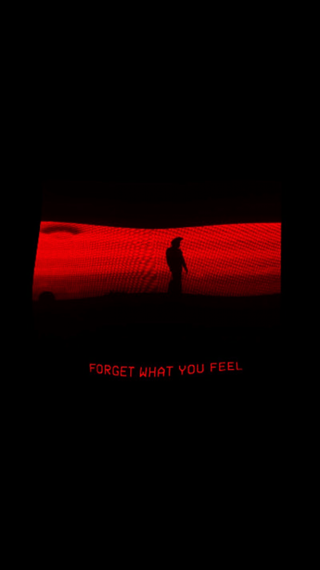 A red screen with a person on it and the words 