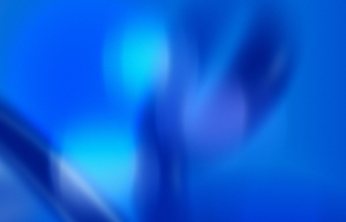 A blue abstract image with a white and blue shape in the bottom left corner - Y2K