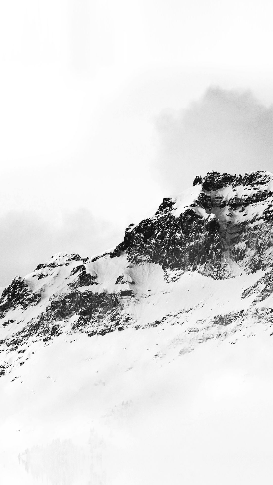 A person is riding down the side of mountain - White, black and white