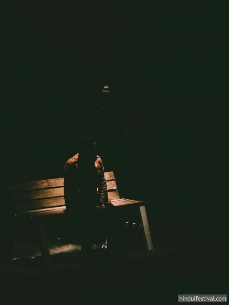 A man sitting on the bench in dark - Sad