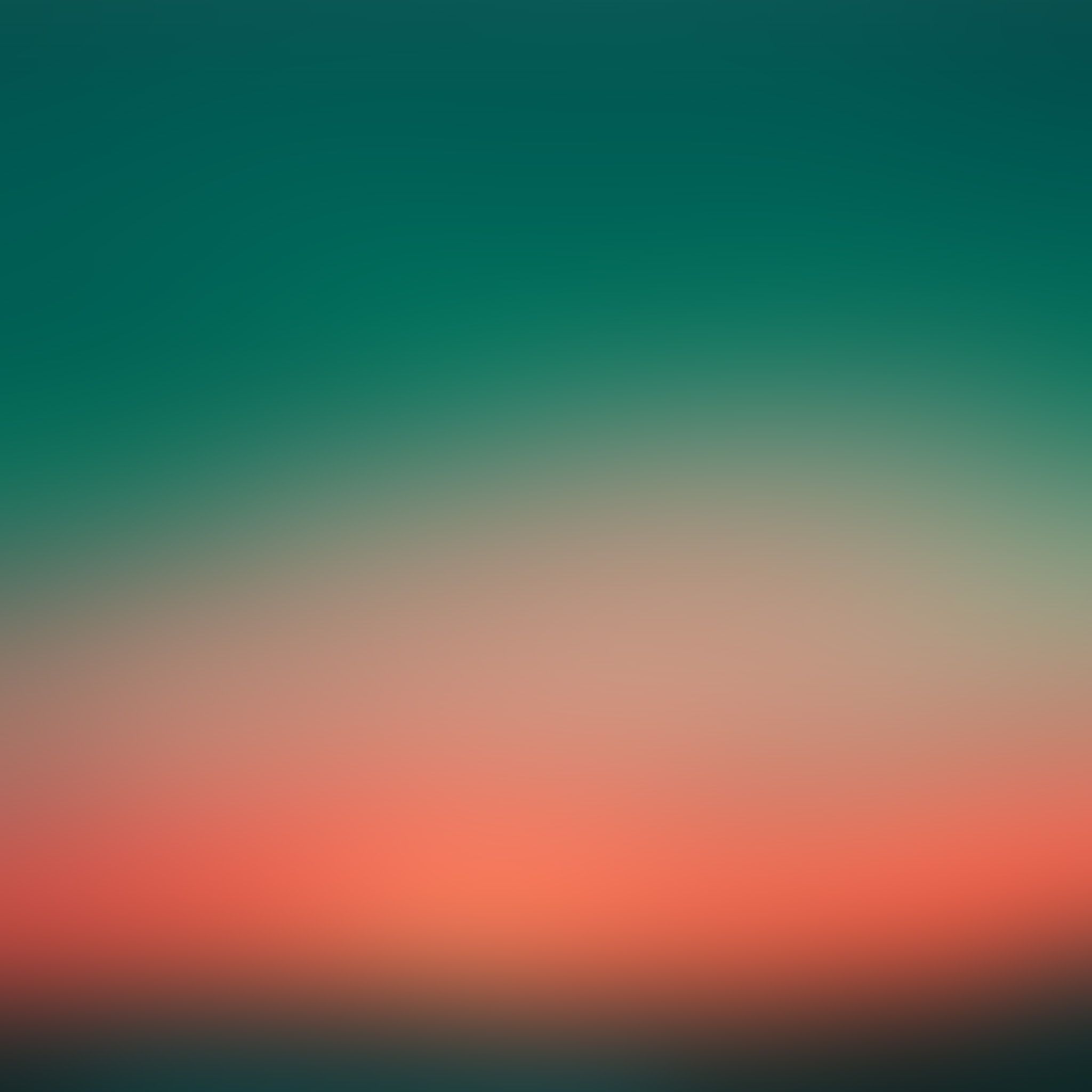 An abstract image of a sunset with a green and orange gradient. - Blurry