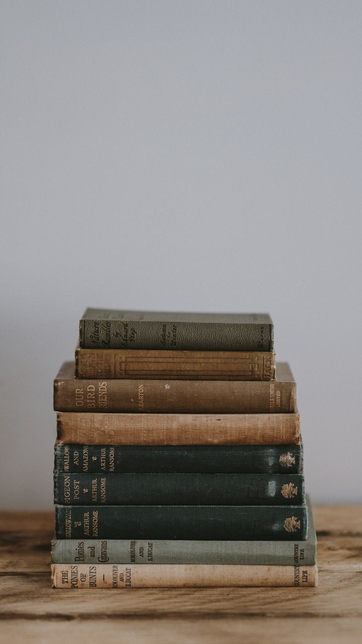 Stack of old books on a wooden table - Books