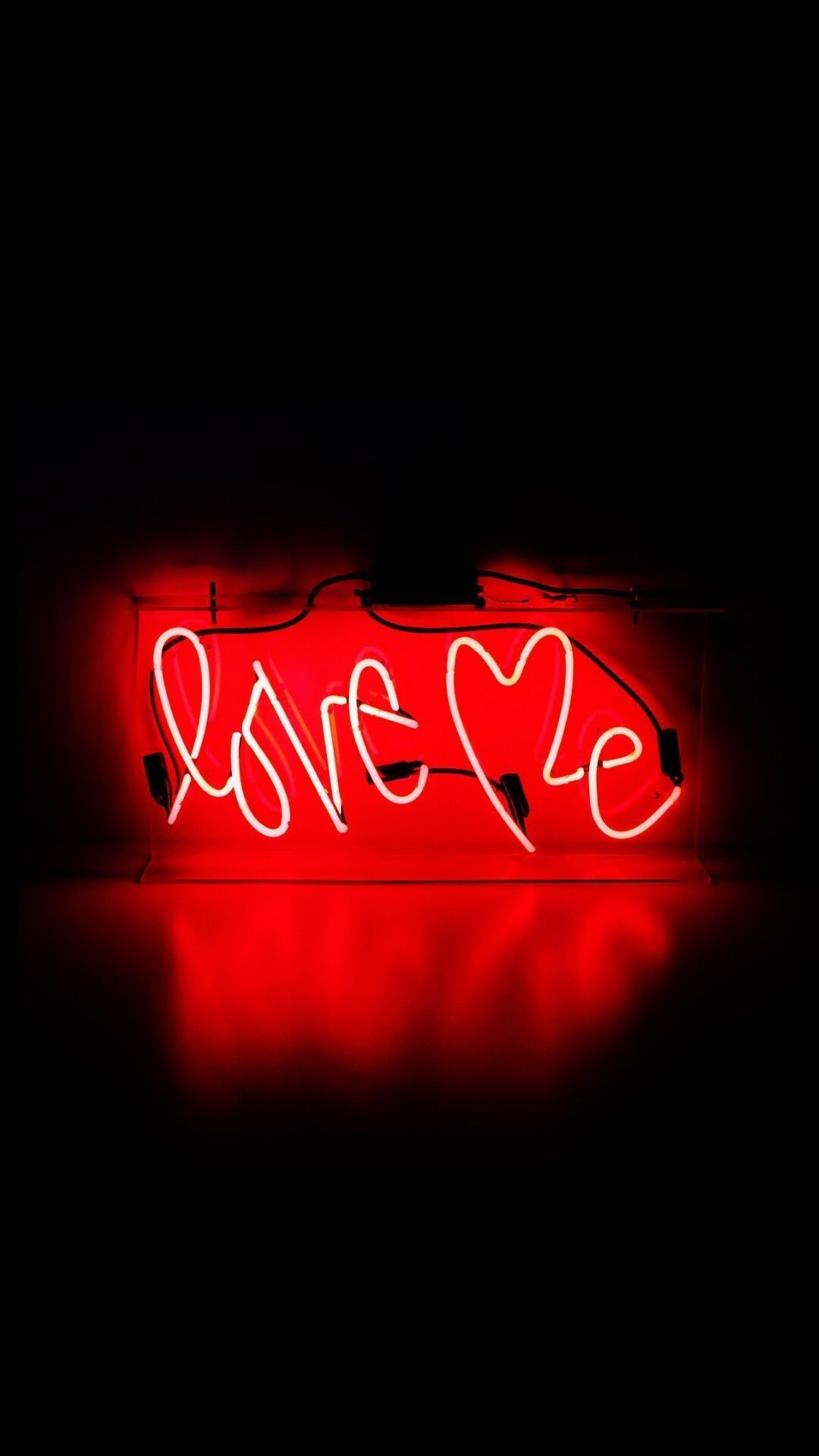 A neon sign that says love me - Dark red