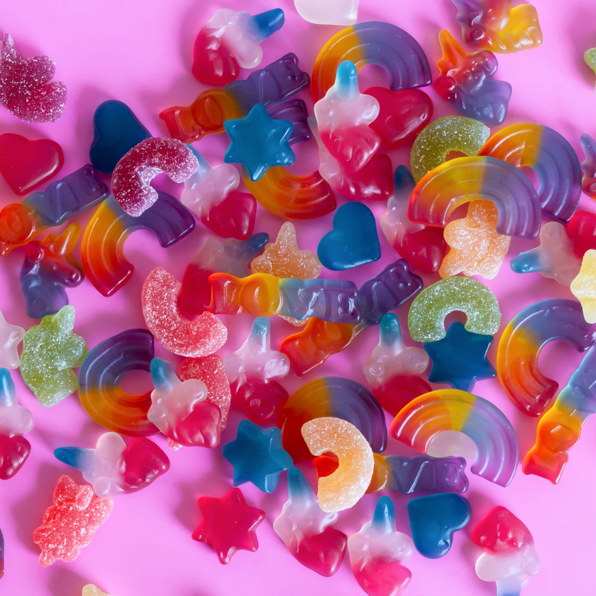 A variety of jelly sweets on a pink background - Kidcore