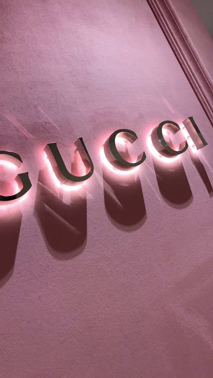 A close up of the gucci logo on pink wall - Rose gold, Gucci