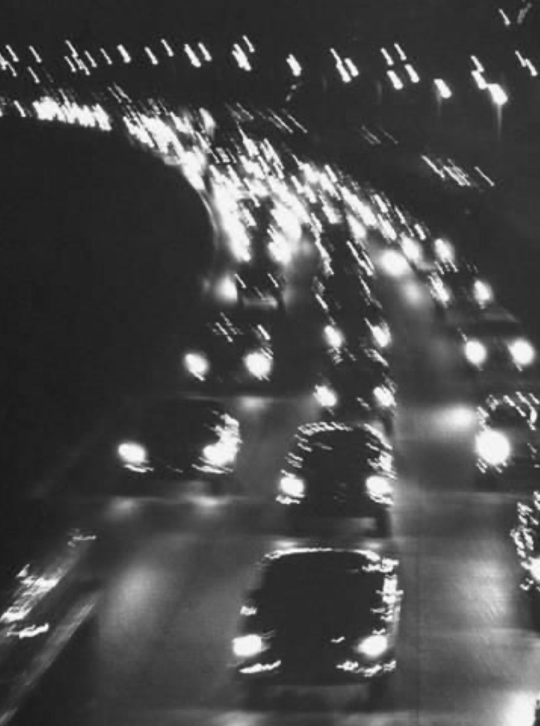 Black and white photograph of a highway at night - Blurry