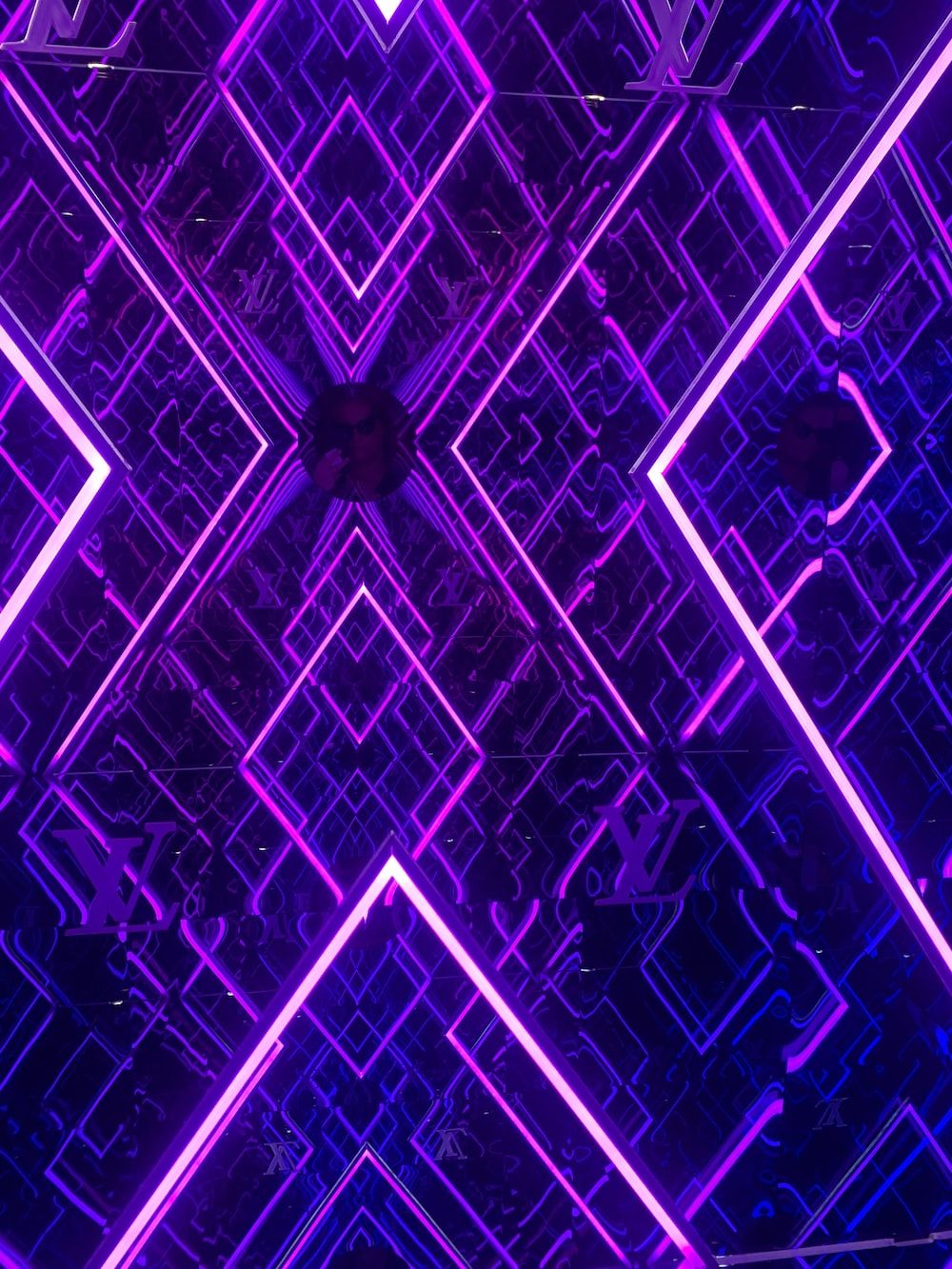A purple neon light with geometric shapes - Neon purple