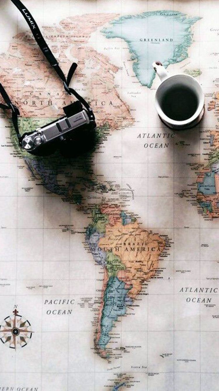 A map with a camera and a cup of coffee on it - Travel