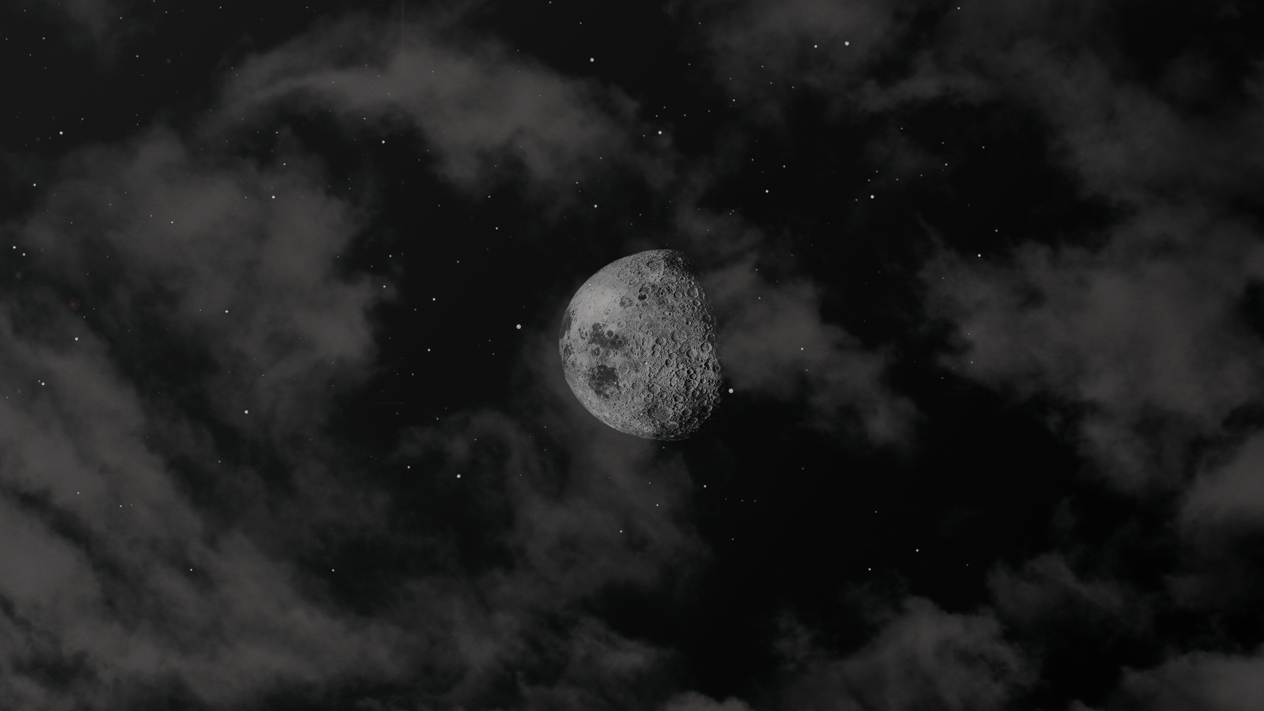 A half moon is seen through a bank of clouds - Dark