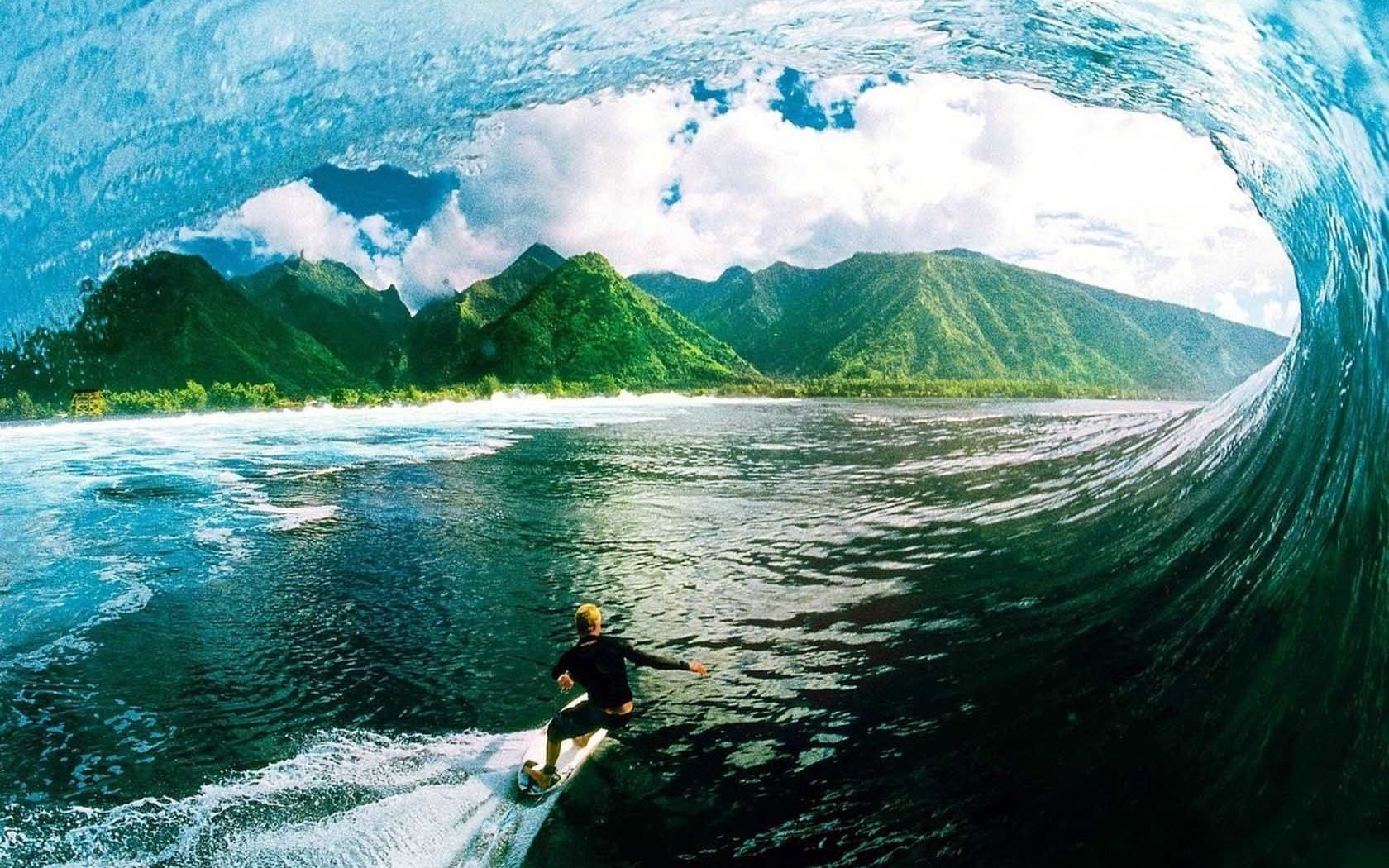 A surfer riding the wave inside of an oceanic tunnel - Surf