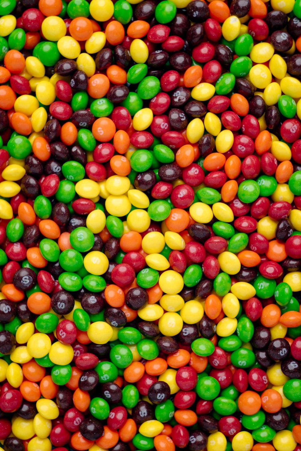 A close up of some candy in different colors - Candy