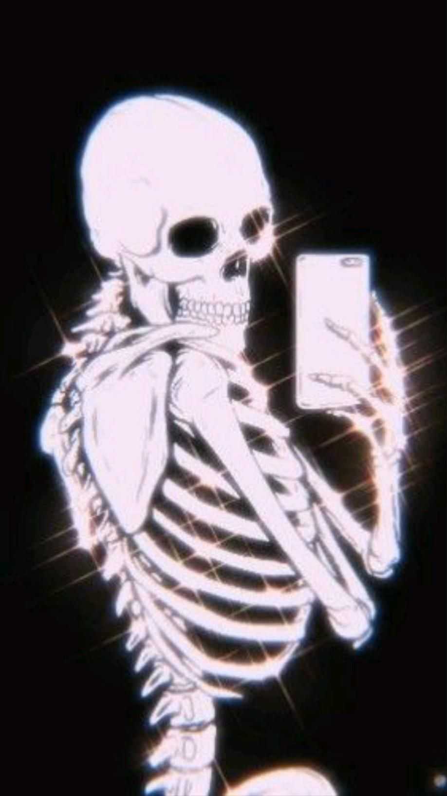 A skeleton holding up an iPhone - Skeleton