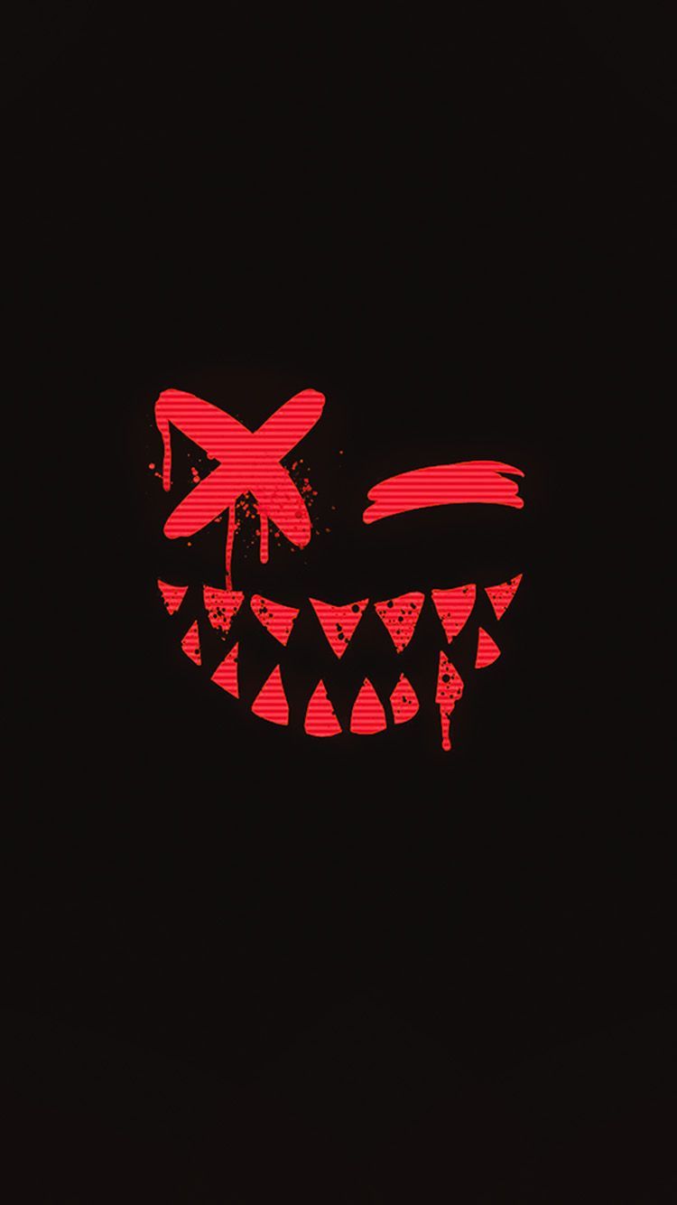 Red neon image of a face with fangs and a bow tie - Horror