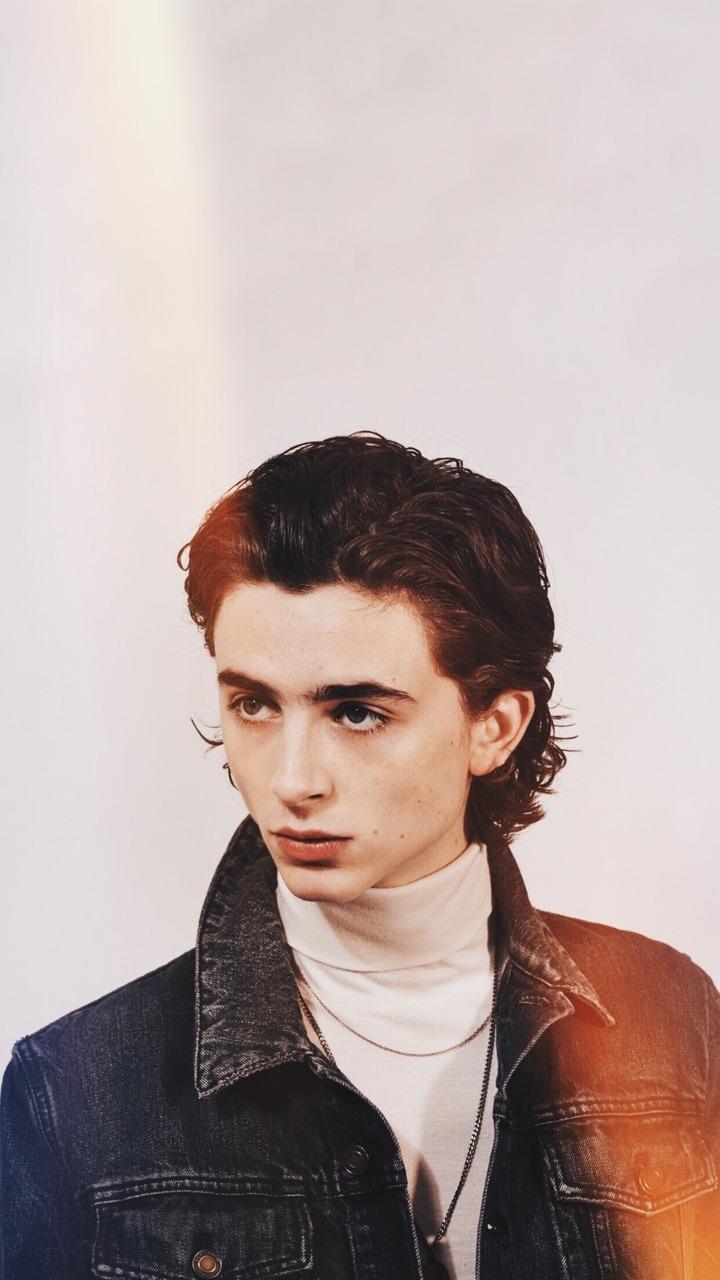A man in black and white with his hair combed back - Timothee Chalamet