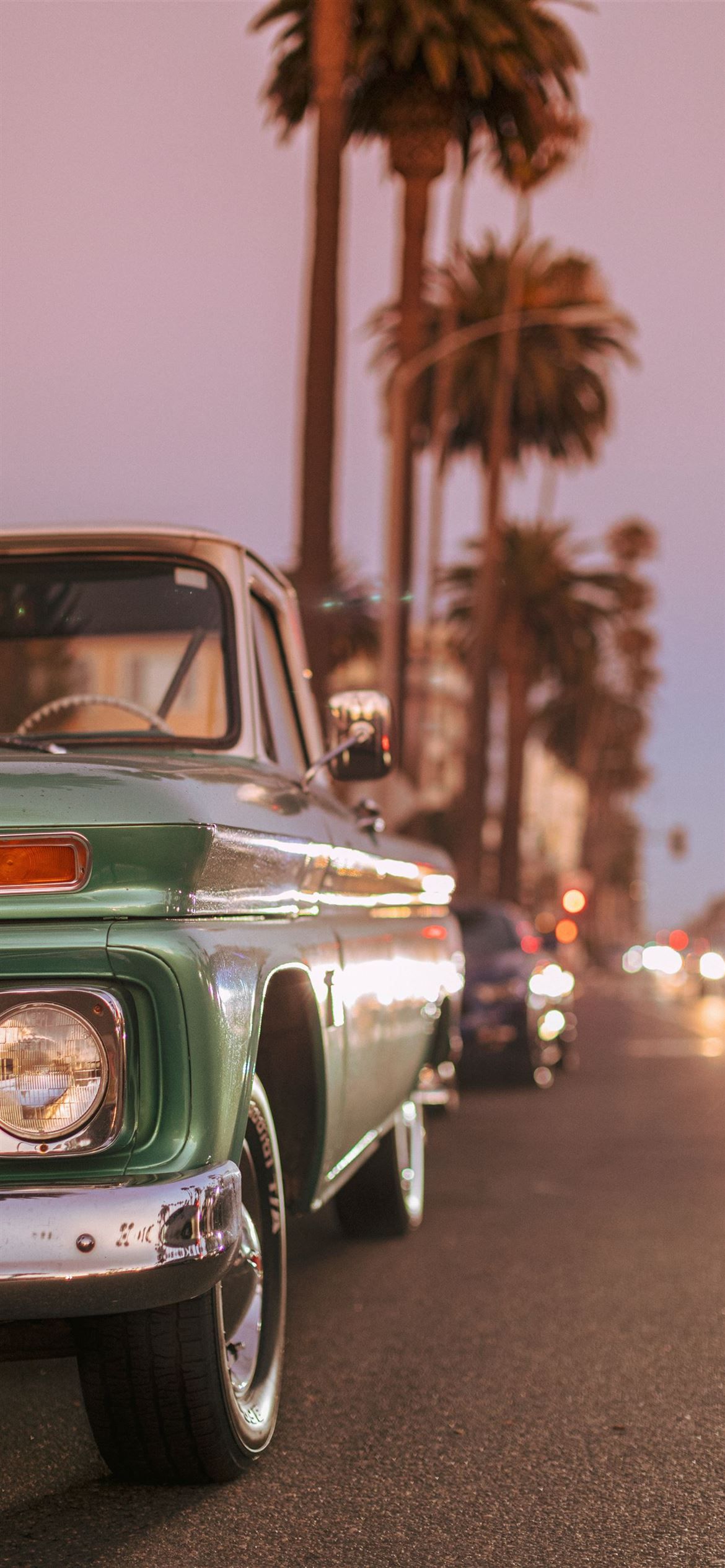 Vintage car parked on Ocean Blvd during sunset iPhone 12 Wallpaper Free Download