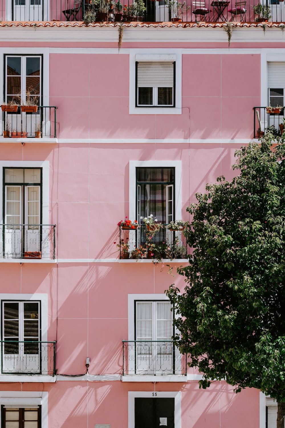 A pink building with balconies and trees - Pink, architecture, Italy, royalcore, blush