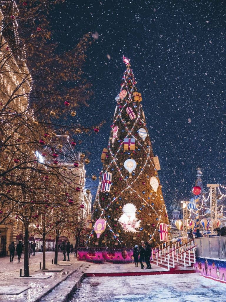 A large Christmas tree in the middle of a snowy street - Christmas