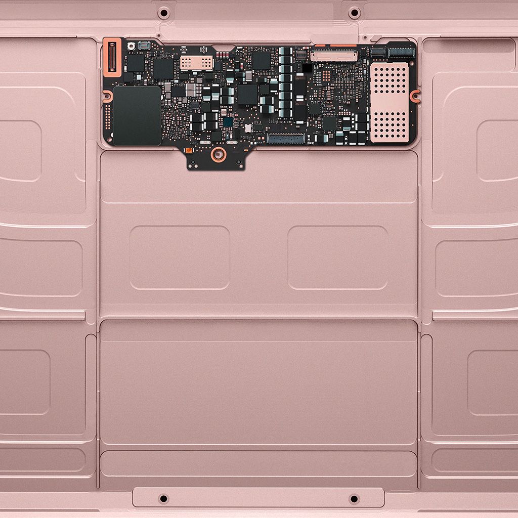 A close-up of the interior of the back of a laptop. - Rose gold