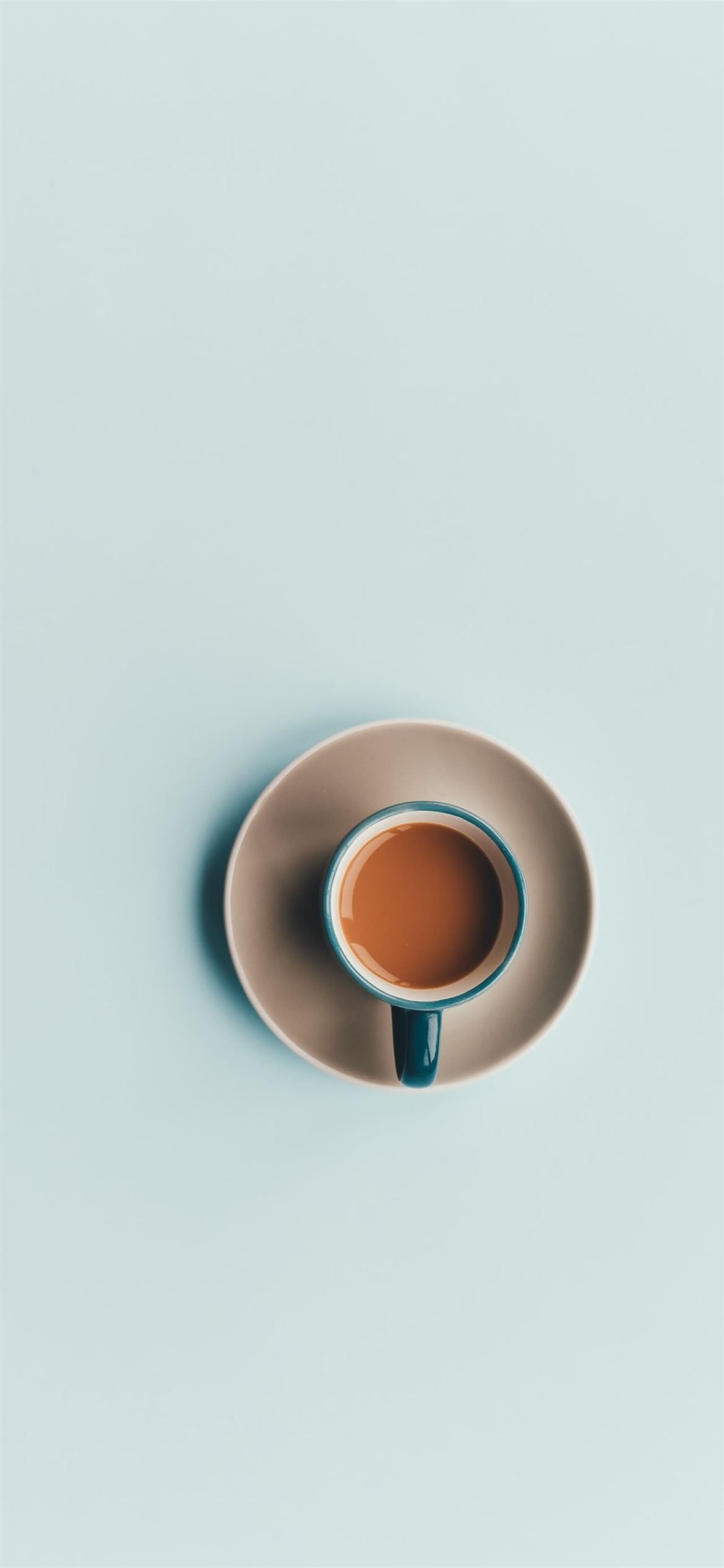 A cup of coffee on a saucer on a blue background - Coffee