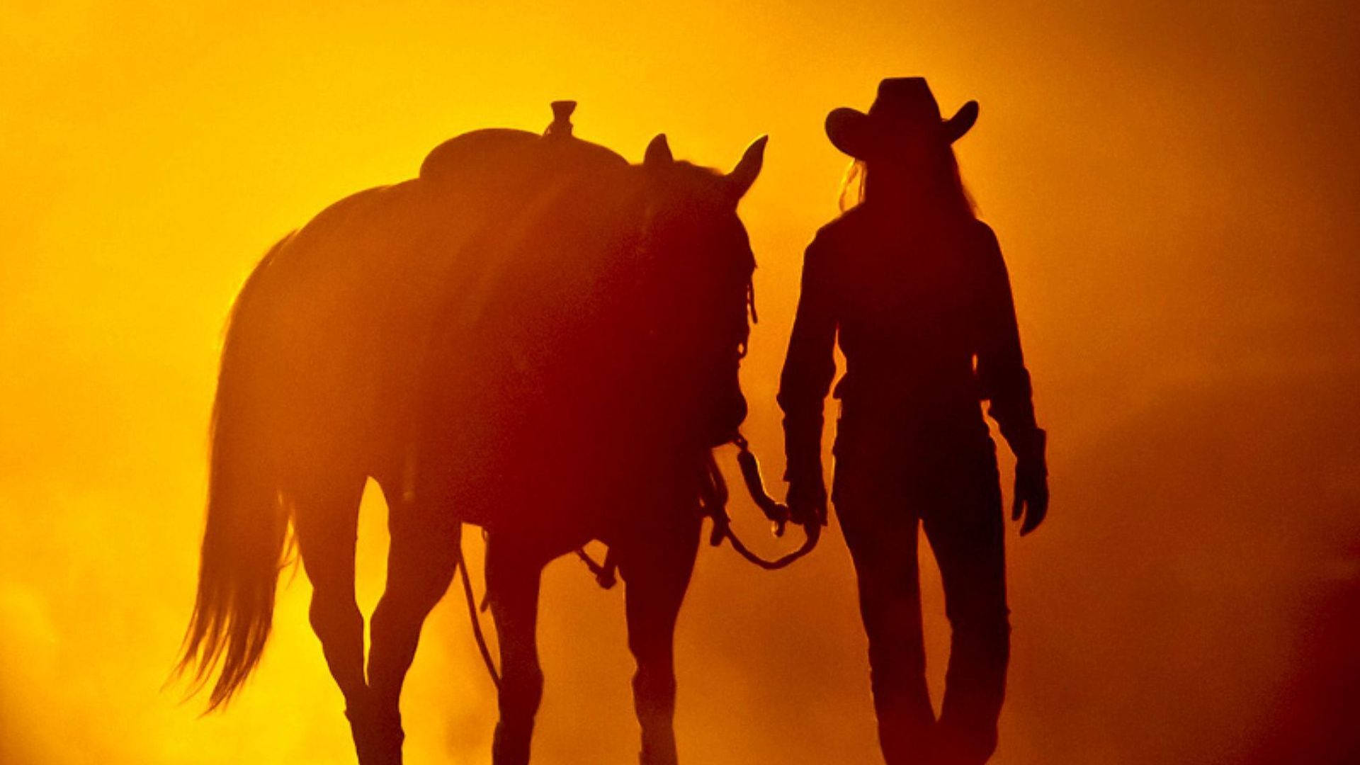 A woman walking with her horse in the sun - Cowgirl