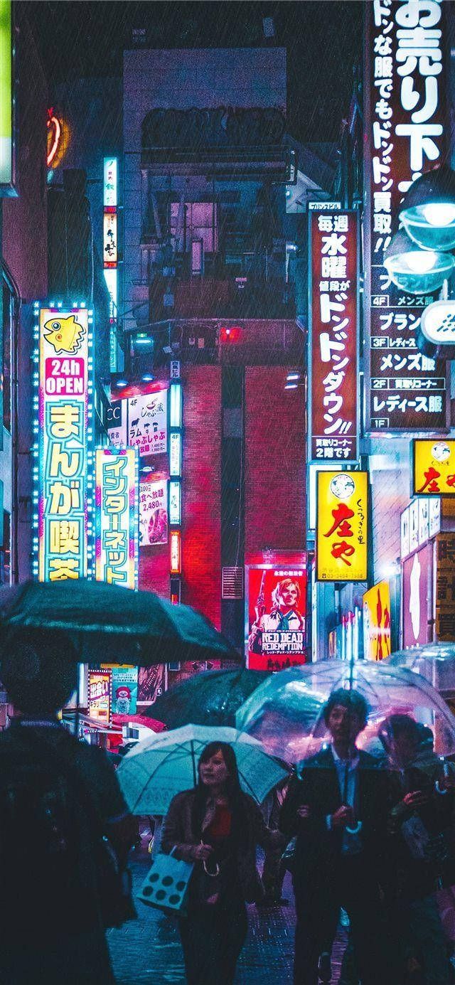 IPhone wallpaper of a busy street in Tokyo at night with people walking with umbrellas. - Japan, Japanese