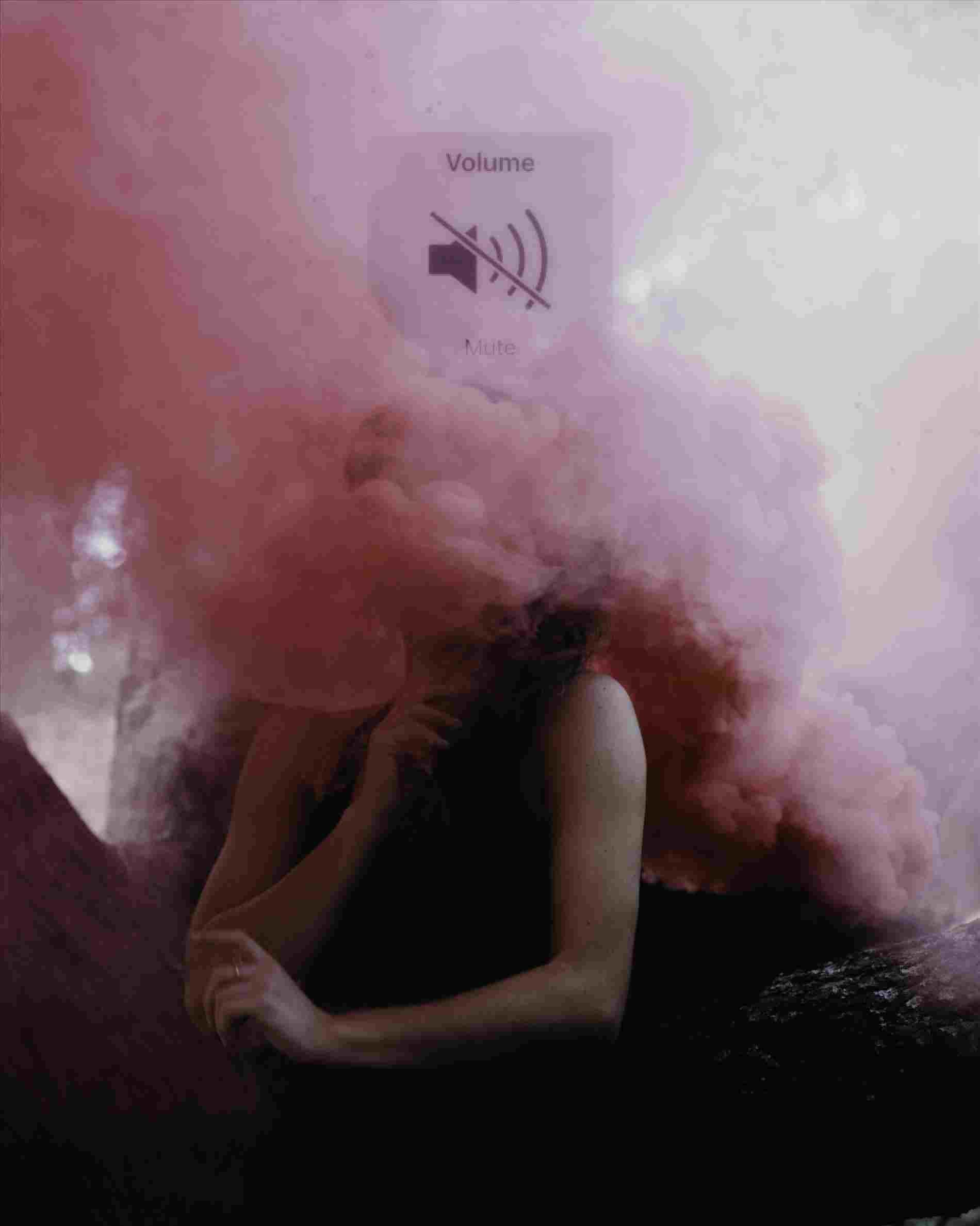 A woman is sitting in front of smoke - Smoke