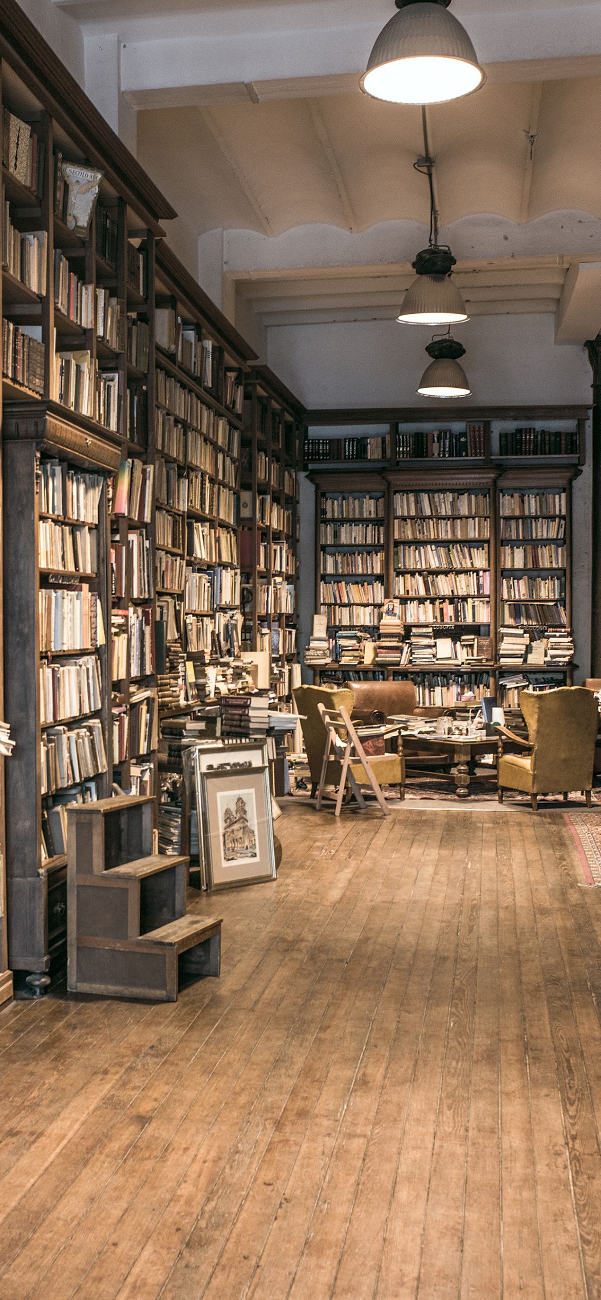 A large room with many book shelves - Library