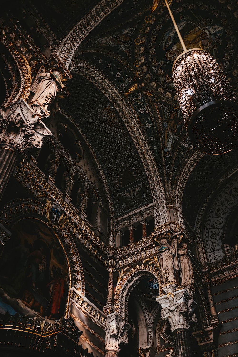 A photograph of the inside of a church with ornate architecture and statues. - Dark academia, royalcore