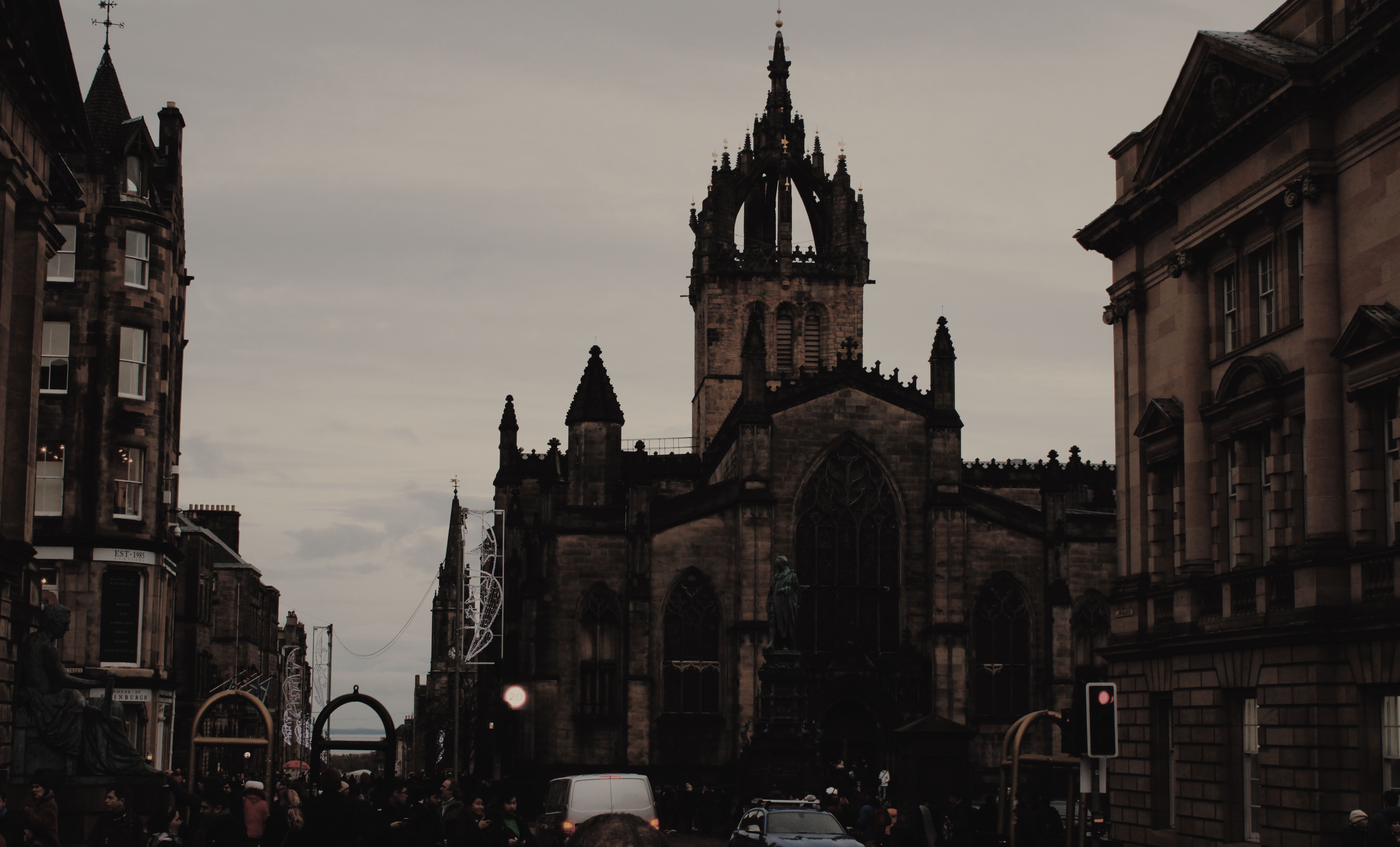 A large cathedral is seen towering over the city of Edinburgh. - Dark academia