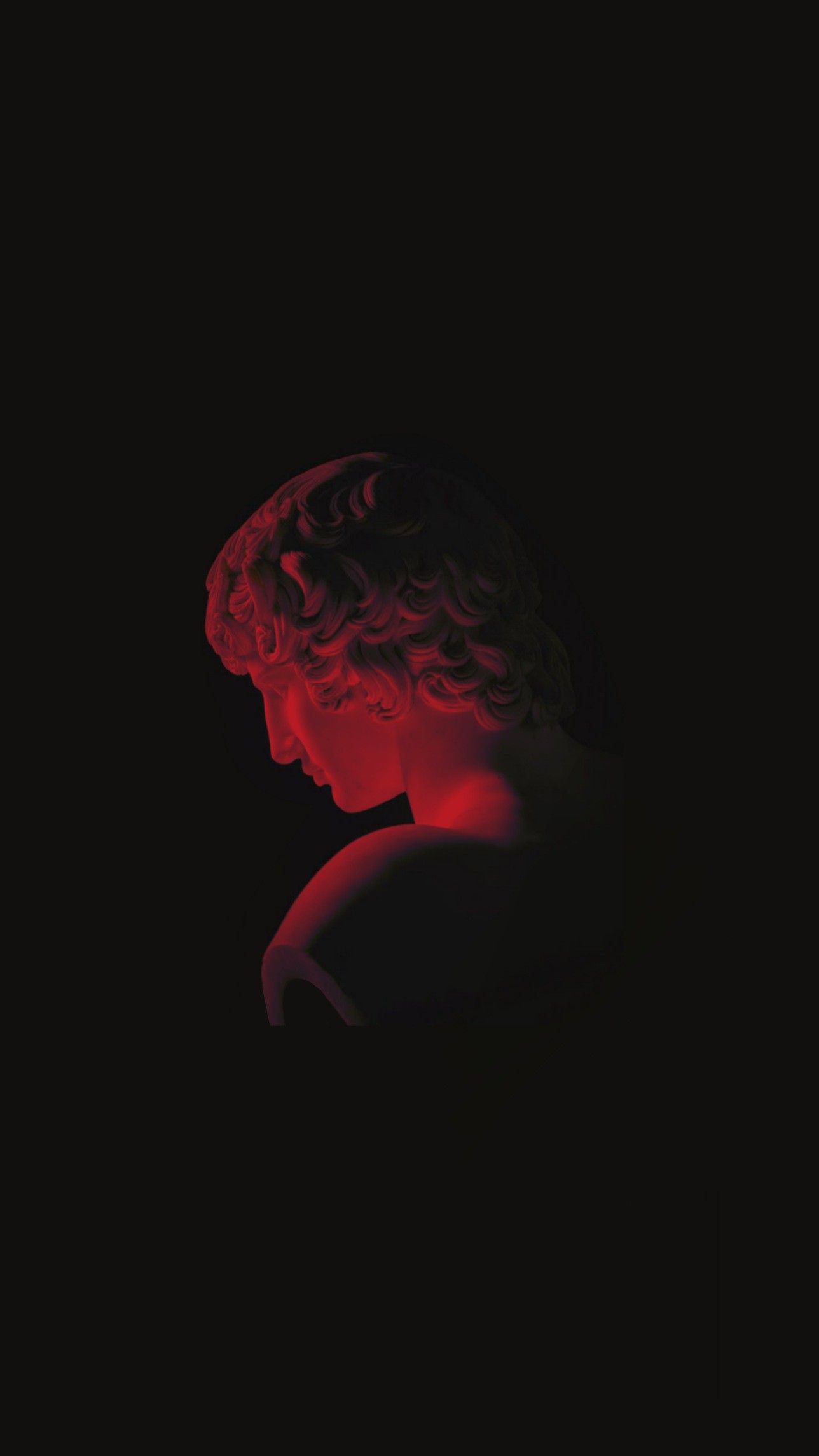 Aesthetic wallpaper of a red statue on a black background - Greek statue