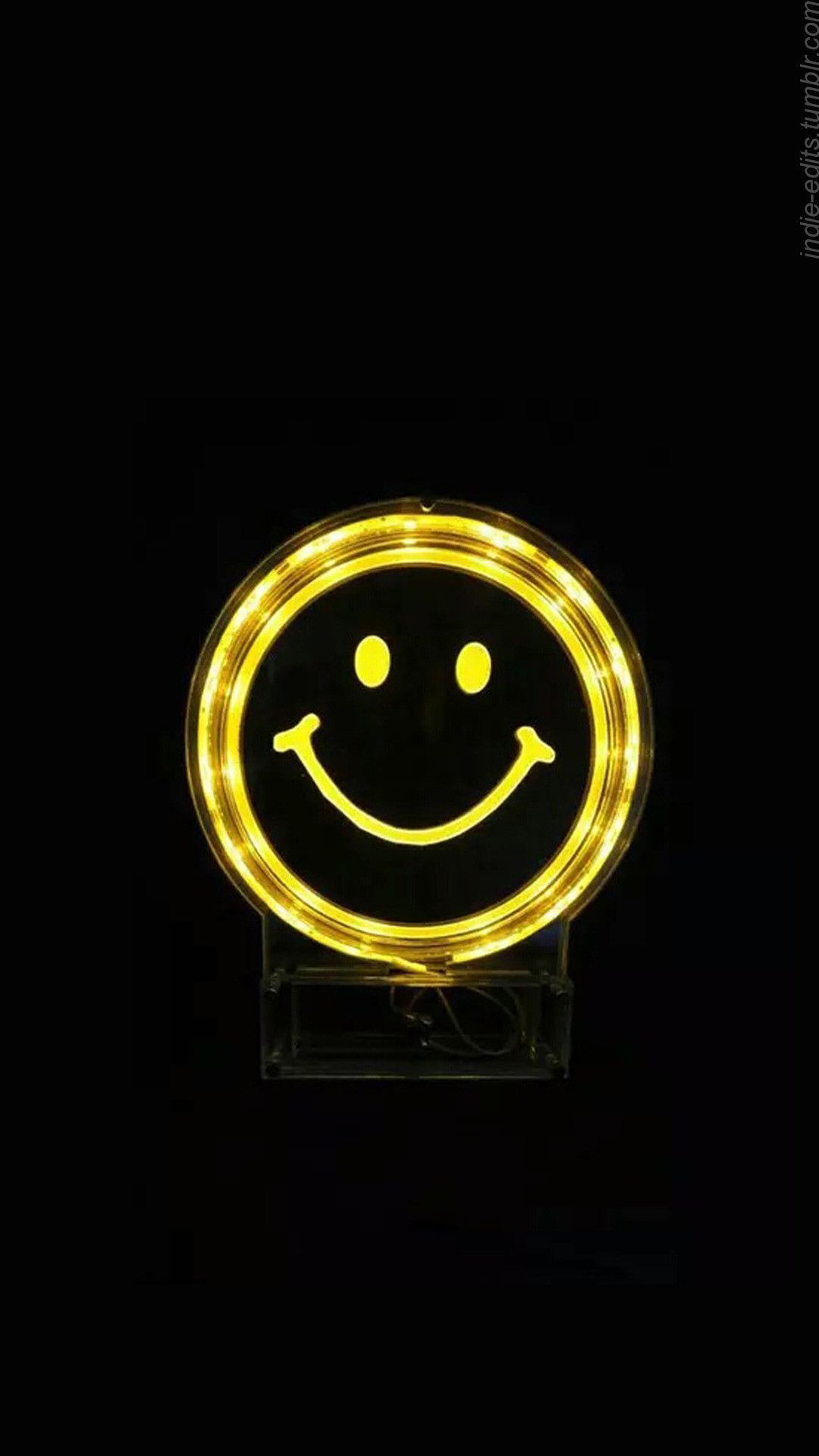 A yellow smiley face light on black background - Smile, yellow