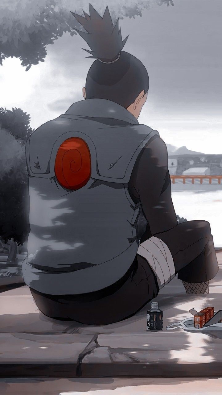 A man sitting on the ground with his back to us - Naruto