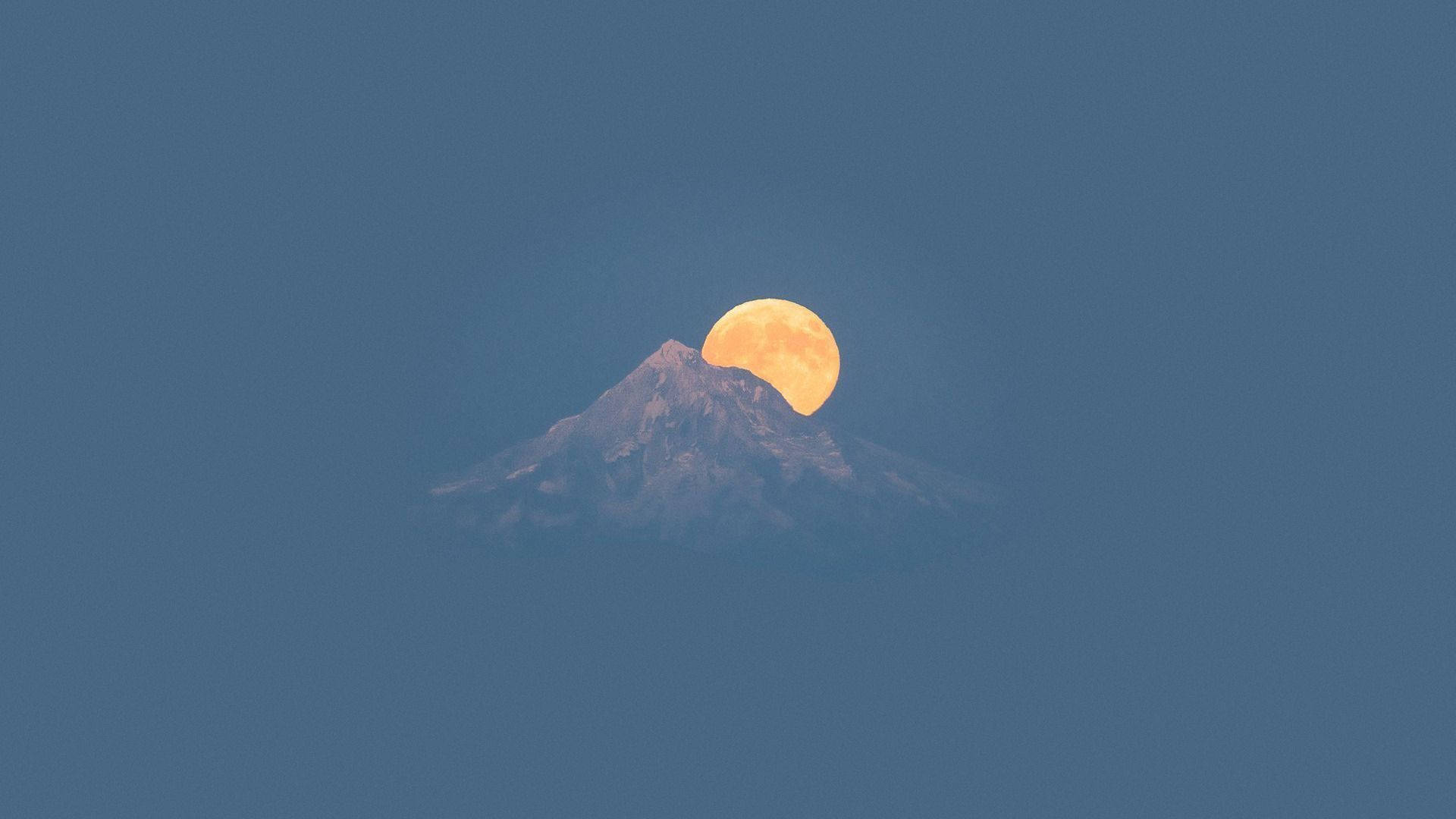A full moon is rising over the top of mountains - Moon